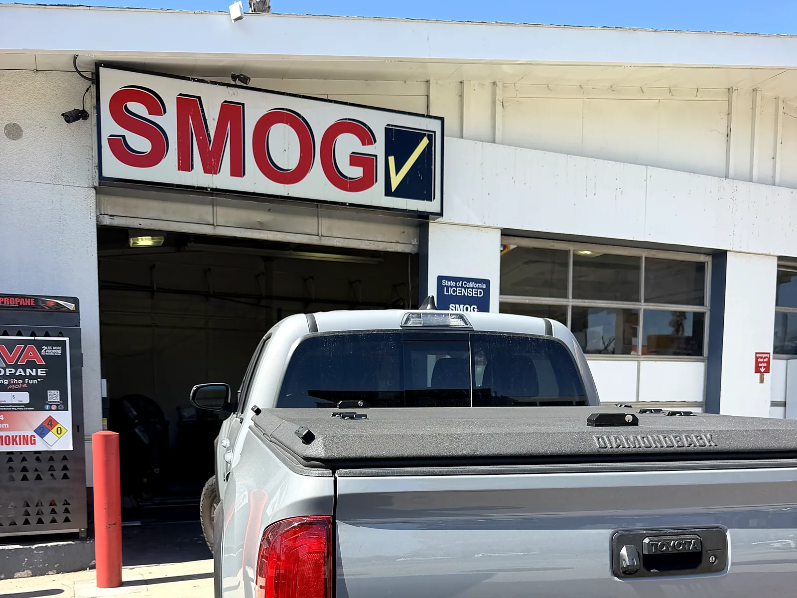 Change-of-ownership smog check in San Diego, CA: Toyota Tacoma pickup at our F Street station under the Smog sign