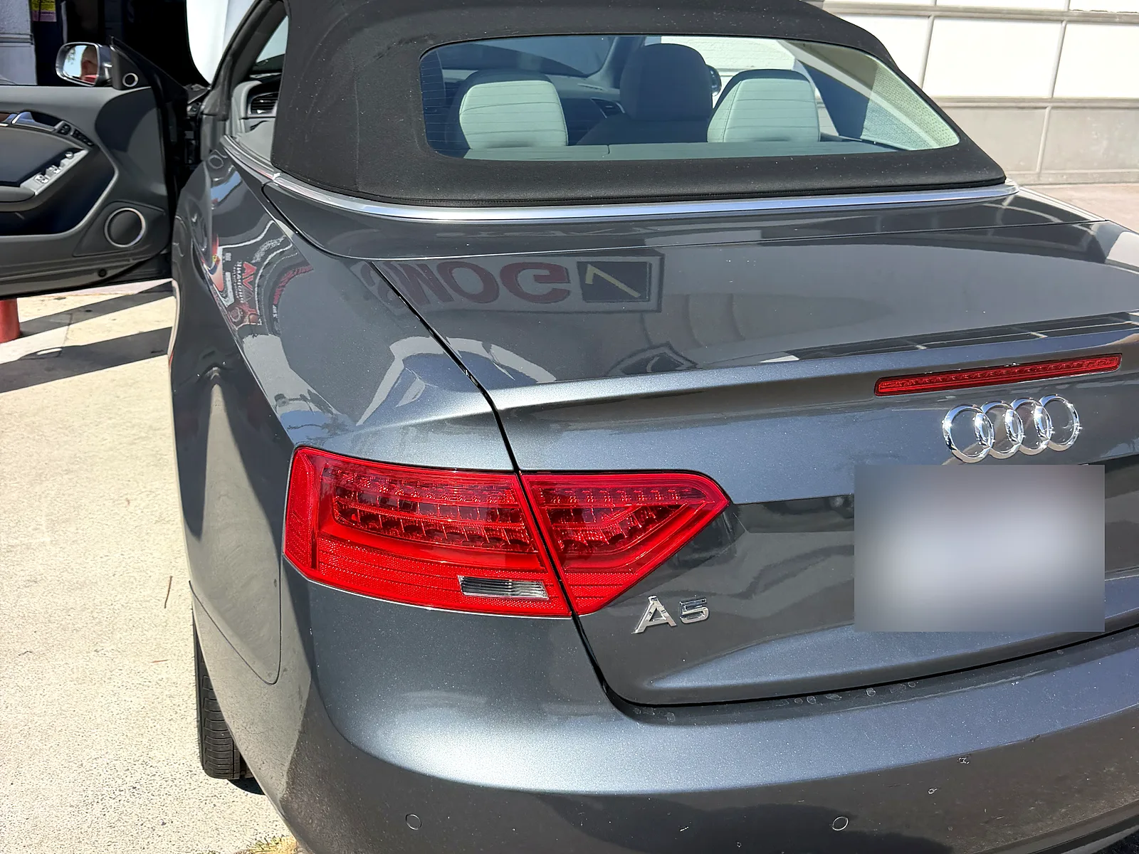 Failed smog check help in San Diego, CA: Audi A5 convertible with the hood up at our station