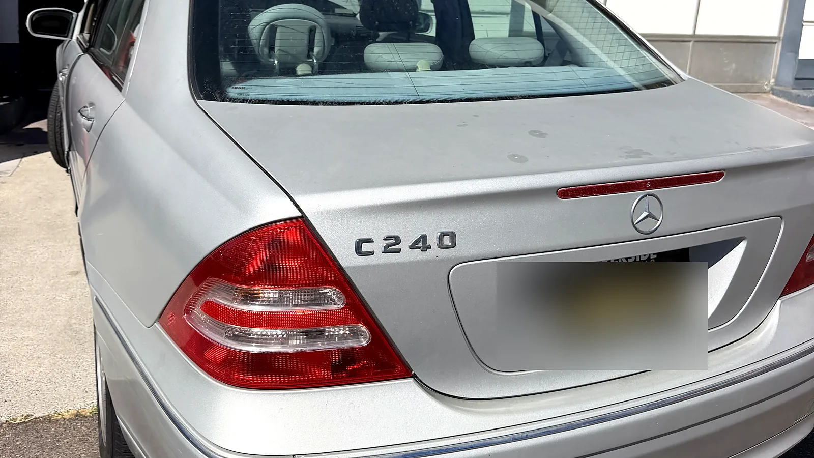 Failed smog check help in San Diego, CA: Mercedes-Benz C240 with the hood up at our station