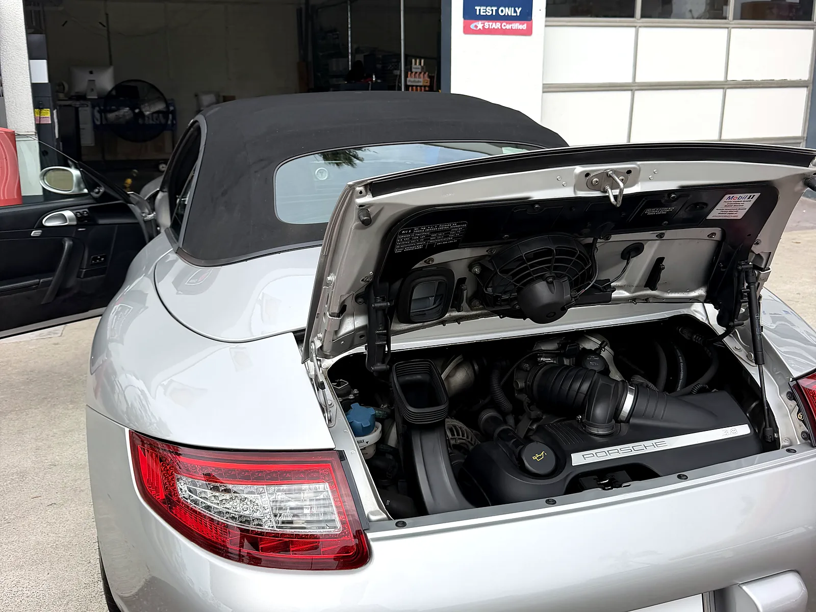STAR smog check in San Diego, CA: Porsche 911 with the engine lid open at our station